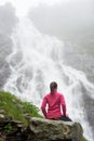 Tourist girl relaxing on rock enjoying beautiful view waterfall Balea Royalty Free Stock Photo