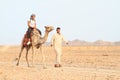 Tourist girl riding a camel