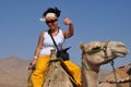 Tourist girl sitting astride a camel, vivid impressions Royalty Free Stock Photo