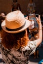 Tourist girl taking a picture with a smartphone of Giants and large heads in Catalonia, Spain