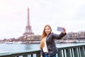 Tourist girl taking selfie in front of Eiffel Tower, Paris Royalty Free Stock Photo