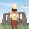 Tourist girl visits the archaeological site of Stonehenge