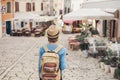 Tourist girl walking in the city during vacation. Cheerful woman traveling abroad in summer. Travel and active lifestyle concept