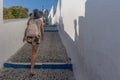 Tourist girl walking in the streets of Fira.