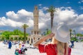 Tourist girl watches Konak Square with old clock tower, Izmir, Royalty Free Stock Photo