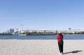 Tourist girl wear hat red sweater at Daiba beach famous landmark at Japan