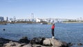 Tourist girl wear hat red sweater at Daiba beach famous landmark at Japan Royalty Free Stock Photo