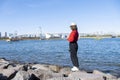 Tourist girl wear hat red sweater at Daiba beach famous landmark at Japan Royalty Free Stock Photo