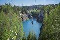 Tourist gliding on the zipline trip in the canyon Marble quarry