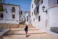 Tourist going up a coblestoned stair in Altea, Spain