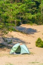 Tourist green tent on the lake.