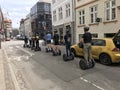 Tourist group having guided Segway city tour in old city.