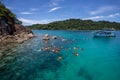 Tourist group snorkeling over coral reef with clear blue ocean water in tropical clear sea Royalty Free Stock Photo