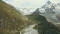 Tourist group walking on mountain trail along rapid river. Climbing a mountain Royalty Free Stock Photo