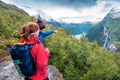 Tourist guide shows a girl waterfall in the mountains of Norway Royalty Free Stock Photo