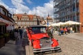 Tourist guides and taxis wait for business in front of the Green Gate in the historic city center of Gdansk