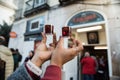 Tourist hands drink Ginjinha or ginja traditional portuguese cherry liqueur