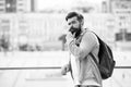 Tourist handsome hipster with backpack stand street. Man with beard and rucksack explore city. Travelling and adventures Royalty Free Stock Photo