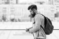 Tourist handsome thoughtful hipster backpack. Man with beard and rucksack explore city. Travelling concept. Tourist on Royalty Free Stock Photo