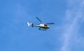 Tourist helicopter flying over clear blue sky