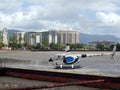 A tourist helicopter on an ocean pontoon at a low tide ready to takeoff with the