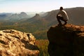 Tourist hiker man on the rock peak in rocky mountains Royalty Free Stock Photo