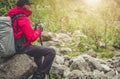 Tourist Hiker Relaxing Seating on a Boulder Royalty Free Stock Photo