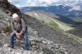 Tourist hiker resting during the heavy climbing on the steep slope in mountain