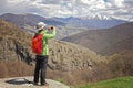 Tourist hiker taking photo using smart phone in Armenian mountains. Royalty Free Stock Photo