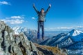 Tourist hikers in the high jump in the background of snowy mountains. Concept of adventure, freedom and active lifestyle Royalty Free Stock Photo