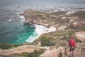 Tourist hiking at Cape Point, looking at view of Cape of Good Hope and Dias Beach, travel destination in South Africa. Table Mount Royalty Free Stock Photo