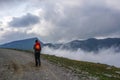 Tourist hiking on a high path in the mountains.