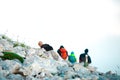 Tourist hiking in the mountains. White rocks with 4 human silhouettes above clouds. Alpine landscape diagonal