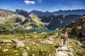 Tourist and hiker on trail in high mountains . Activity in alpine style scenery. High mountain lanscape in Europe. Royalty Free Stock Photo