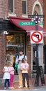 Tourist and his three children at the crosswalk in Beacon Hill Street