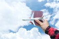 Tourist holding airplane and passport flight travel traveler fly on the blue sky for travelling citizenship air on the around worl Royalty Free Stock Photo