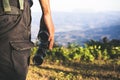 Tourist is holding through binoculars on sunny cloudy sky from mountain top. Royalty Free Stock Photo