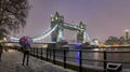 A tourist holding a british flag umbrella standing in front of the illuminated Tower Bridge Royalty Free Stock Photo