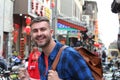 Tourist holding sugar-coated haws on a stick in China