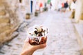 Tourist holds Fritule on street in Croatia. Croatian homemade fr Royalty Free Stock Photo