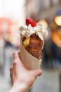 Woman holds in hand Trdlo or Trdelnik, it is a national street street food of Prague