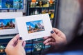 Tourist holds a postcard with a picture of a popular place in Budapest