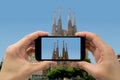 Tourist holds up camera phone at sagrada familia