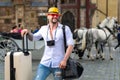 Tourist on holiday. Handsome young man on business trip walking with his luggage on street. Travelling businessman. Royalty Free Stock Photo