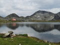 Tourist hut by mountain lake Royalty Free Stock Photo