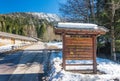 Tourist information board and mountain road with some snow