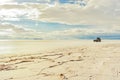 Tourist Jeep is driving through Salar Uyuni, Bolivia