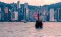 Tourist junk boat in Hong Kong moving from Kowloon harbour at Victoria harbour Royalty Free Stock Photo