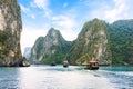 Tourist junks floating between limestone karsts and isles in Ha long Bay, Vietnam Royalty Free Stock Photo