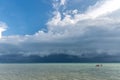 Tourist kayaking in the emerald Thailand sea at the cloudy blue sky background Royalty Free Stock Photo